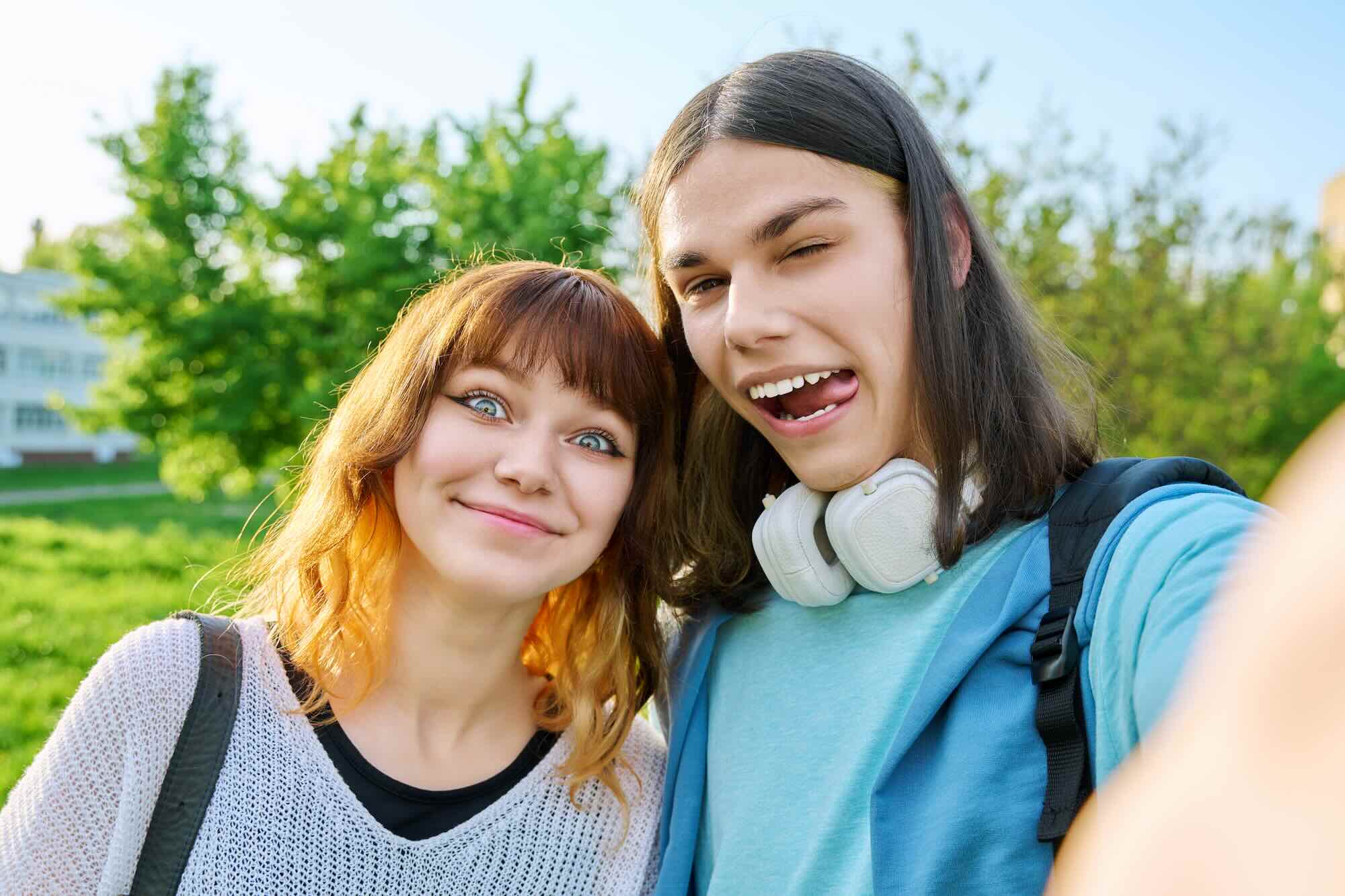 there are two women taking a selfie together in the park