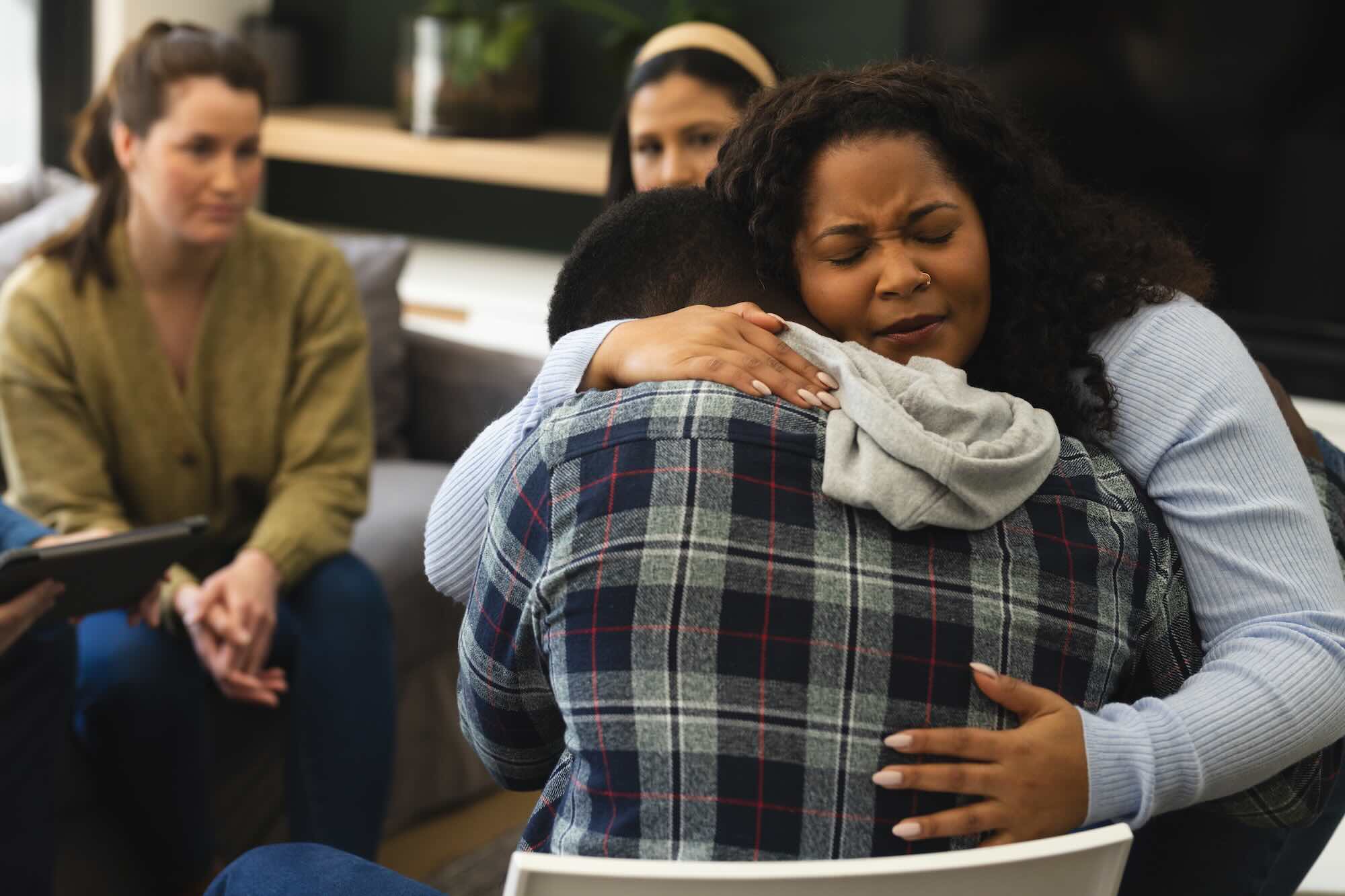 Two African American Male And Female Friends Hugging On Therapy Session. Mental Health, Therapy, Friendship And Support, Unaltered.