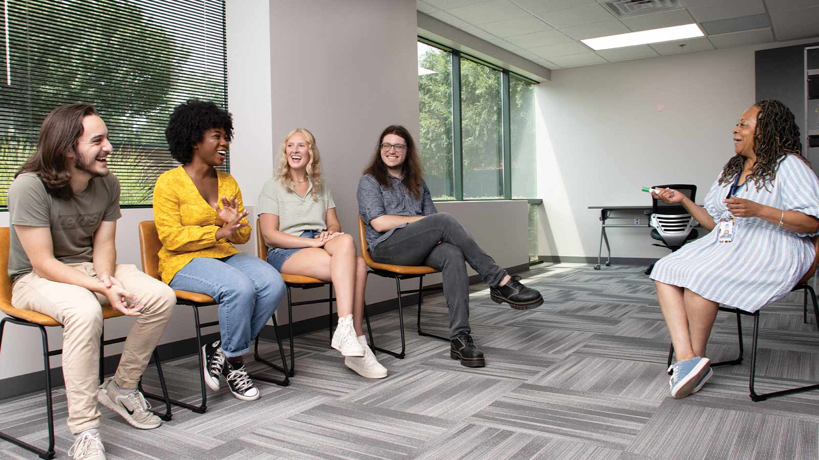 four young adults in an academic session