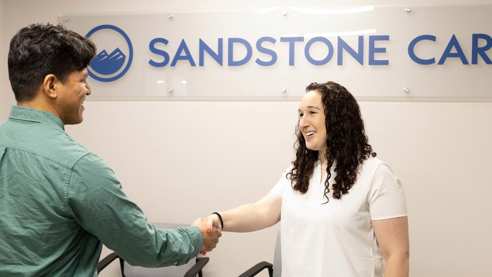 A man and woman shaking hands.