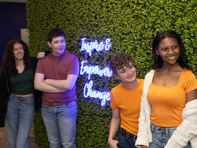 Teens In Front Of Neon Sign