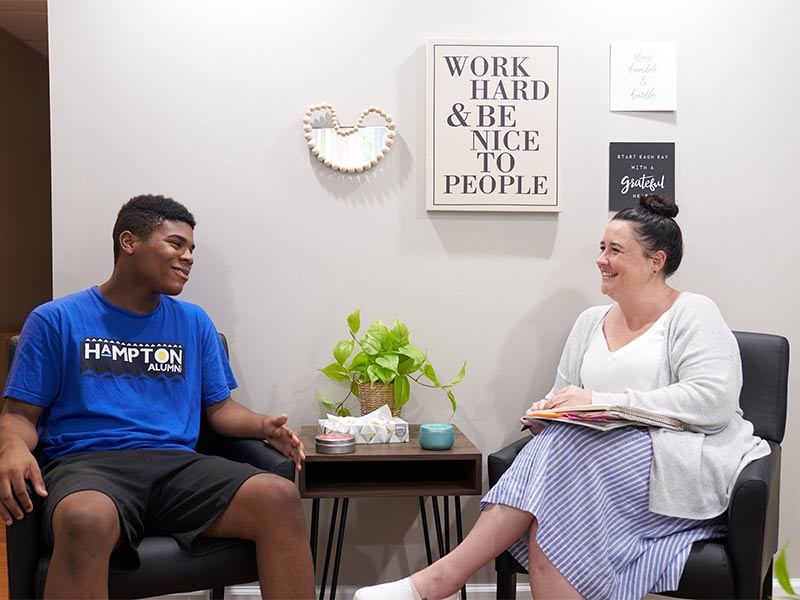 there are two people sitting in chairs talking to each other