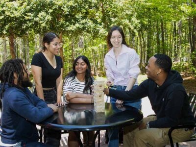 Young Adults Outside Playing Jenga