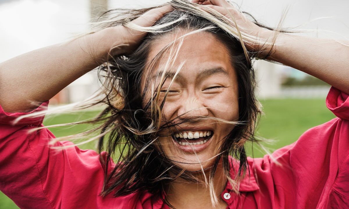 Asian girl smiling on camera outdoor - Focus on face