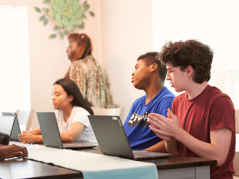 Teens studying together with a tutor