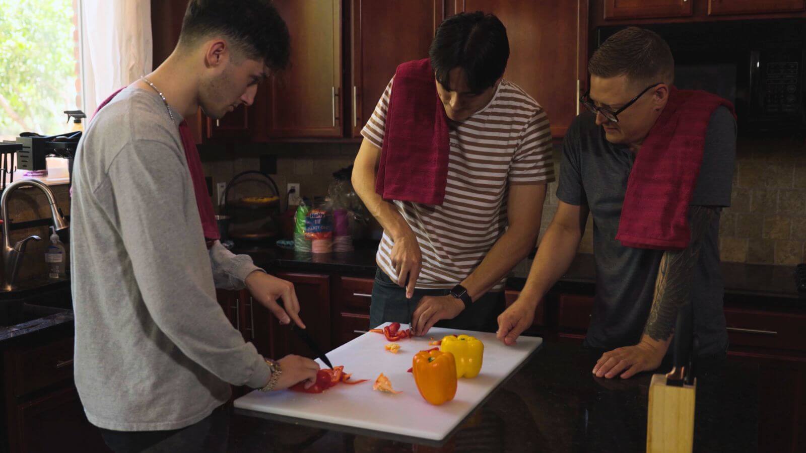 Men in transitional living learning life skills like cooking.