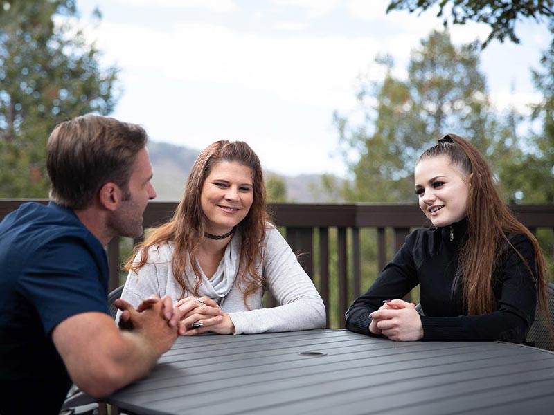 a teenager and her mother with a therapist